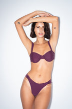 Balconette bikini top by nema swim in purple with adjustable straps and removable cups. Shop now